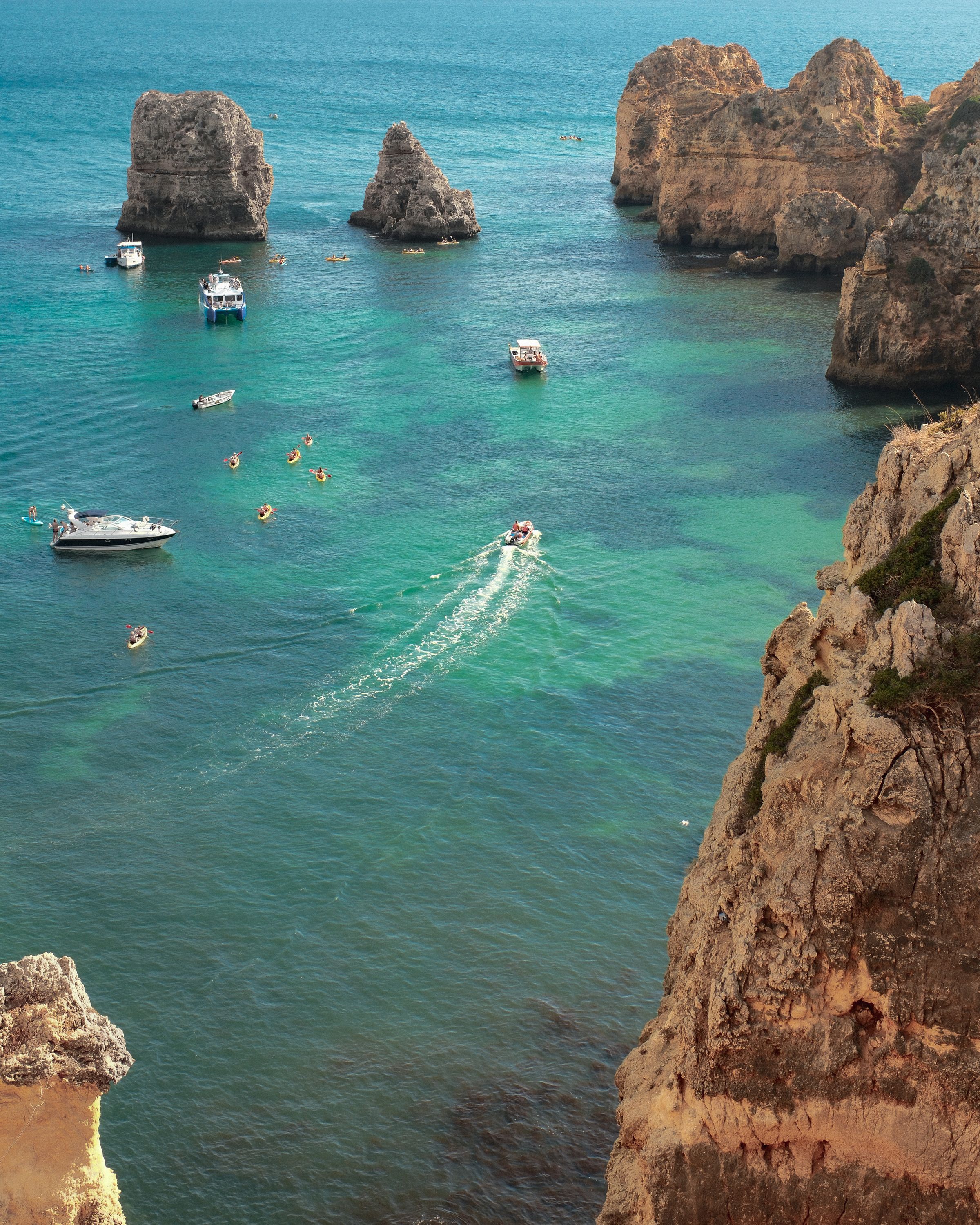 Boats and turquoise water between the cliffs at Ponta da Piedade, Lagos